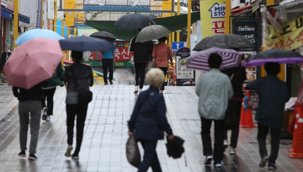 가을비가 내리는 29일 오전 시민·관광객들이 우산을 쓰고 강원도 속초시 속초관광수산시장으로 걸어가고 있다.(사진=뉴시스)